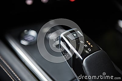 Automotive detail in a luxury car. Modern Luxury car inside. Interior of prestige modern car. Automatic gear stick shift Stock Photo