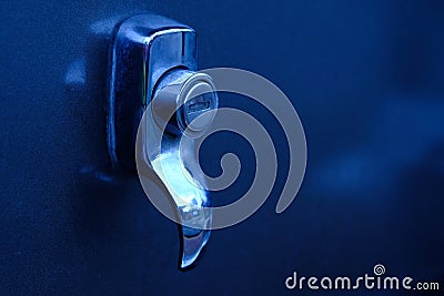 Close up of silver car keyhole with blue light Stock Photo