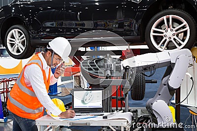 Automotive engineer with assistance robotic inspec modern car Stock Photo