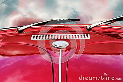 Automotive Nostalgia: Retro Red Car with Reflected Clouds Stock Photo