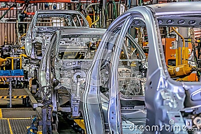 Automotive production lines revolutionized the automotive industry. They made building cars more efficient. Stock Photo