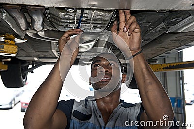 Automotive Technician Examining Vehicle Stock Photo