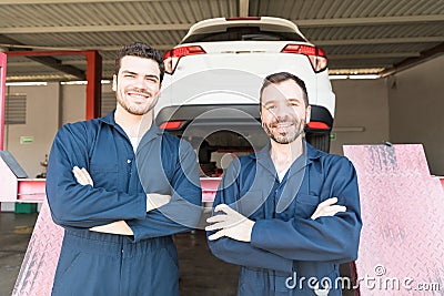 Automotive Workers Showing Contentment In Garage Stock Photo