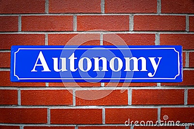 Autonomy street sign on brick wall Stock Photo