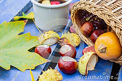 Autumn, autumn leaves, a hot Cup of tea with apples on the background of a wooden table. Stock Photo