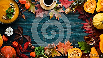 Autumn background with coffee, pumpkin, autumn leaves. flat lay. On a blue wooden background. Top view. Stock Photo