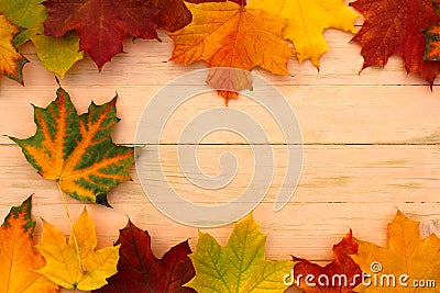 Autumn background. On a wooden board lie yellow leaves at the edges. Stock Photo