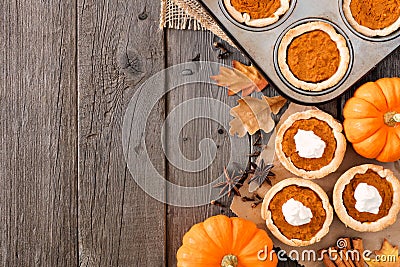 Autumn baking side border with pumpkin tarts over wood Stock Photo