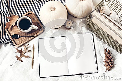 Autumn breakfast in bed composition. Blank open notepad, diary mockup. Cup of coffee, white pumpkins, plaid, oak leaves Stock Photo