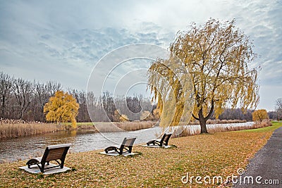 Autumn in the city park. Quiet place beside the river Stock Photo