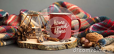 Autumn coffee cup with candle, spices and blanket decorations on wooden board, cozy fall deco concept, home sweet home Stock Photo