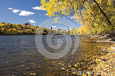 Autumn colors along the Mississippi River, Minneapolis skyline in the distance. Stock Photo