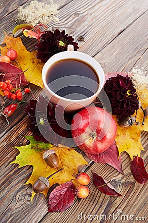Autumn composition - coffee, maple leaves and flowers on wooden background. Seasonal autumn concept with drink. Stock Photo