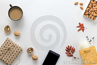 Autumn composition. Cup of coffee, sartphone, dried leaves on a white background. Autumnal, flat lounger, top view. Copy Stock Photo