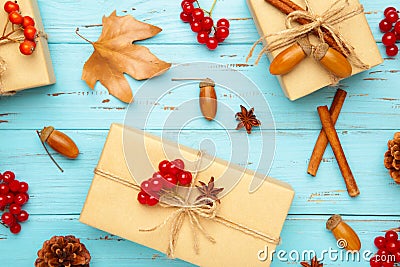 Autumn composition and gifts on blue background. Pattern made of autumn leaves, acorn, pine cones Stock Photo