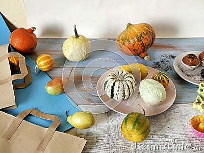 Autumn composition of pumpkins of different varieties, cupcakes, pears, cookie shapes Stock Photo
