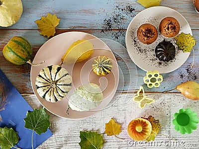 Autumn composition of pumpkins of different varieties, cupcakes, pears, cookie shapes Stock Photo