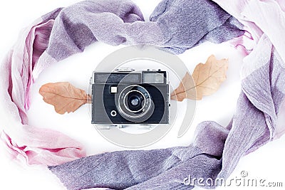 Autumn composition. Retro camera, autumn leaves and scarf on a white background. Nostalgia for autumn. The view from the Stock Photo