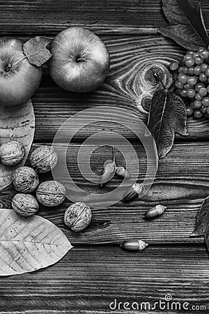 Autumn composition on a wooden background. Apples, viburnum, leaves and flowers Stock Photo