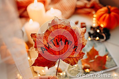 Autumn concept presented by a maple leaf, candles, pumpkins Stock Photo