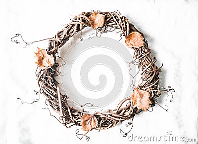 Autumn decorative vine wreath on a light background, top view. Stock Photo