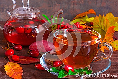 Autumn drink. cup of hot berry tea and teapot Stock Photo