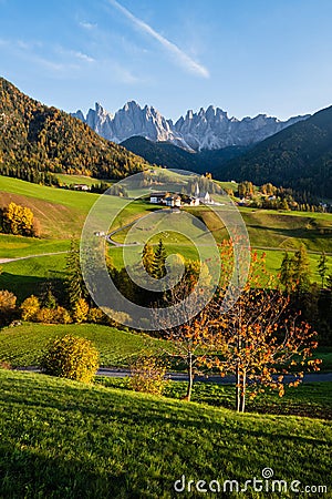 Autumn evening Santa Magdalena famous Italy Dolomites village view in front of the Geisler or Odle Dolomites mountain rocks. Stock Photo