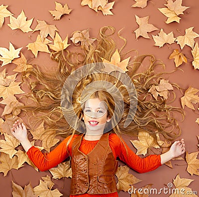 Autumn fall little blond girl on dried tree leaves Stock Photo