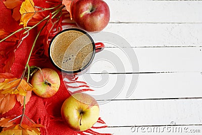 Autumn flatlay background with cup of coffee, yellow leaves and and red apples on white wooden table, copy space Stock Photo