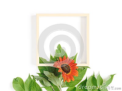 Autumn flower arrangement. Empty frame template decorated with sunflower and green leaves. Seasonal autumn concept. White Stock Photo