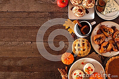 Autumn table scene side border of pies, appetizers and desserts. Top view over a wood background with copy space. Stock Photo