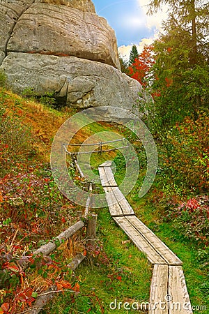 Autumn forest in the mountains and stairs in rock Stock Photo