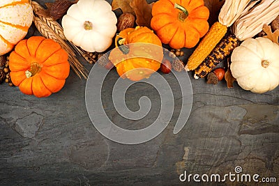 Autumn harvest top border over a slate background Stock Photo