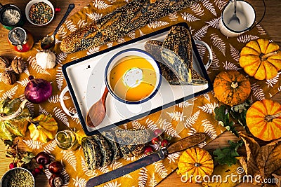 Autumn healthy vegetarian meal pumpkin cream soup with herbs and vegetables, thanksgiving food background Stock Photo