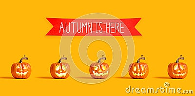 Autumn is here message with orange pumpkins Stock Photo