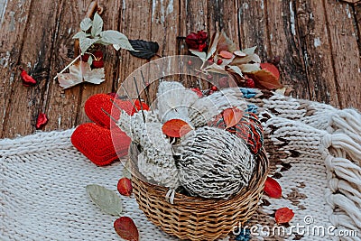 Autumn knitting of warm clothes. Woolen balls of knitting needles knitted hearts. Self-made things with love. Idea for Stock Photo