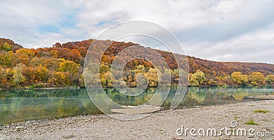 Autumn landscape. Boats on the river near a picturesque hill Stock Photo