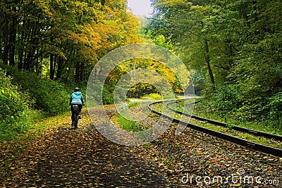 Autumn landscape of a lone cyclist on the Great Allegheny Passage Stock Photo