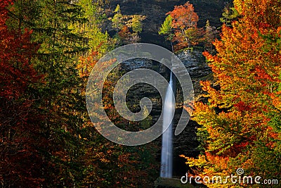 Autumn landscape in Slovenia, nature in Europe. Pericnik waterfall, Triglav Alps with orange forest, travel in Slovenia. Stock Photo
