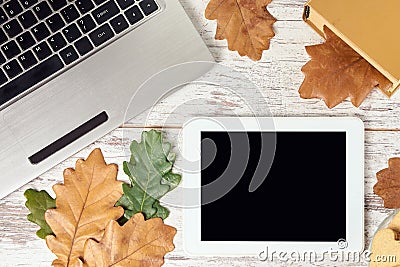 Autumn leaves. Modern tablet. Gray notebook Stock Photo