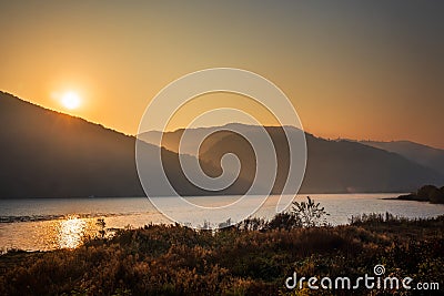 Autumn morning on the river surrounded by mountains Stock Photo