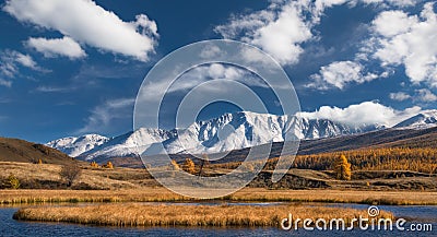 Autumn Mountain Landscape. Snow Mountain Tops With The Blue Cloudy Sky And The Yellow Valley With Larch. Stock Photo