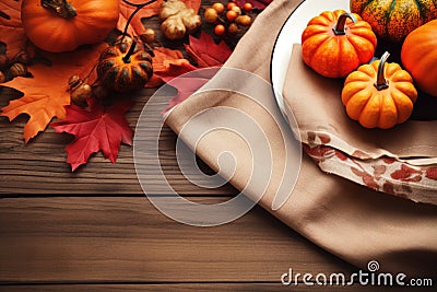 Autumn place setting with fall leaves, napkin and pumpkins. Thanksgiving autumn place setting with cutlery and arrangement of fall Stock Photo
