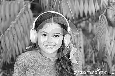 Autumn playlist concept. Feel joy. Kid girl relaxing near autumn tree with headphones. Music for autumn cozy mood Stock Photo