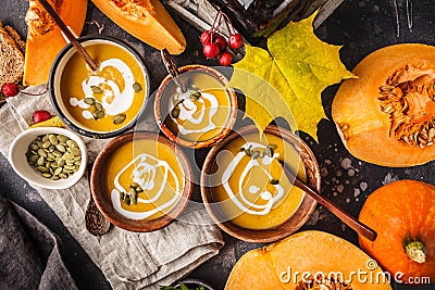 Autumn pumpkin soup puree with cream in cups, the autumn scenery Stock Photo