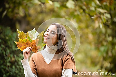 Autumn romance woman with leaves. Female model on foliage day. Dream and lifestyle. Beauty outdoor portrait. Carefree Stock Photo