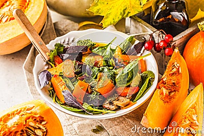 Autumn salad with baked pumpkin, beet, zucchini and carrots. Healthy vegan food concept Stock Photo