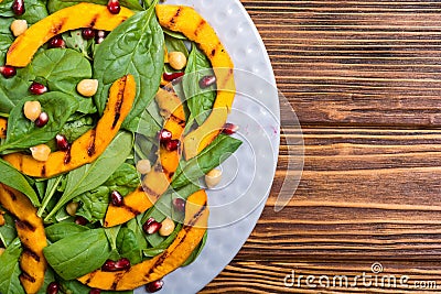 Autumn salad with pumpkin spinach , pomegranate and chickpea . Healthy vegan food Stock Photo