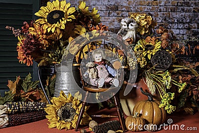 Autumn scene of doll among sunflowers and pumpkins Stock Photo