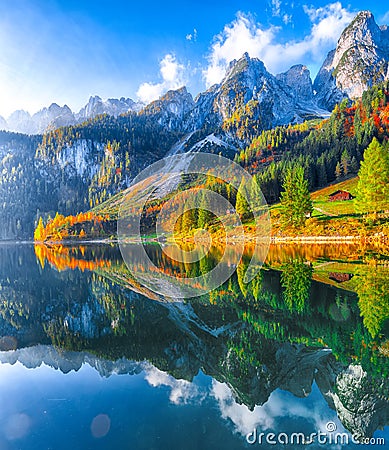 autumn scenery with Dachstein mountain summit reflecting in crystal clear Gosausee mountain lake Stock Photo